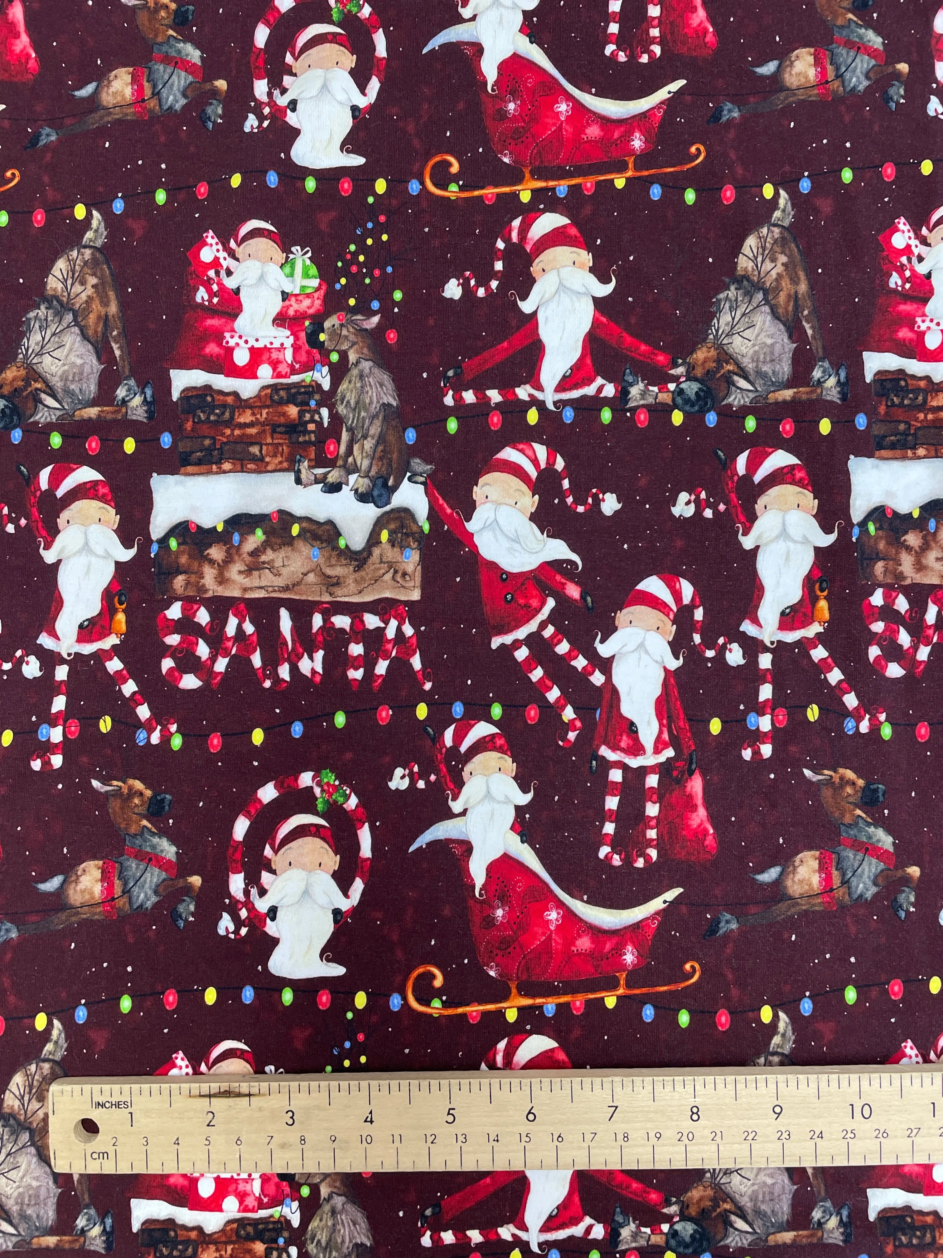 SALE 3/4 YD Cotton/Spandex Remnant - Maroon with Whimsical Santas & Reindeer
