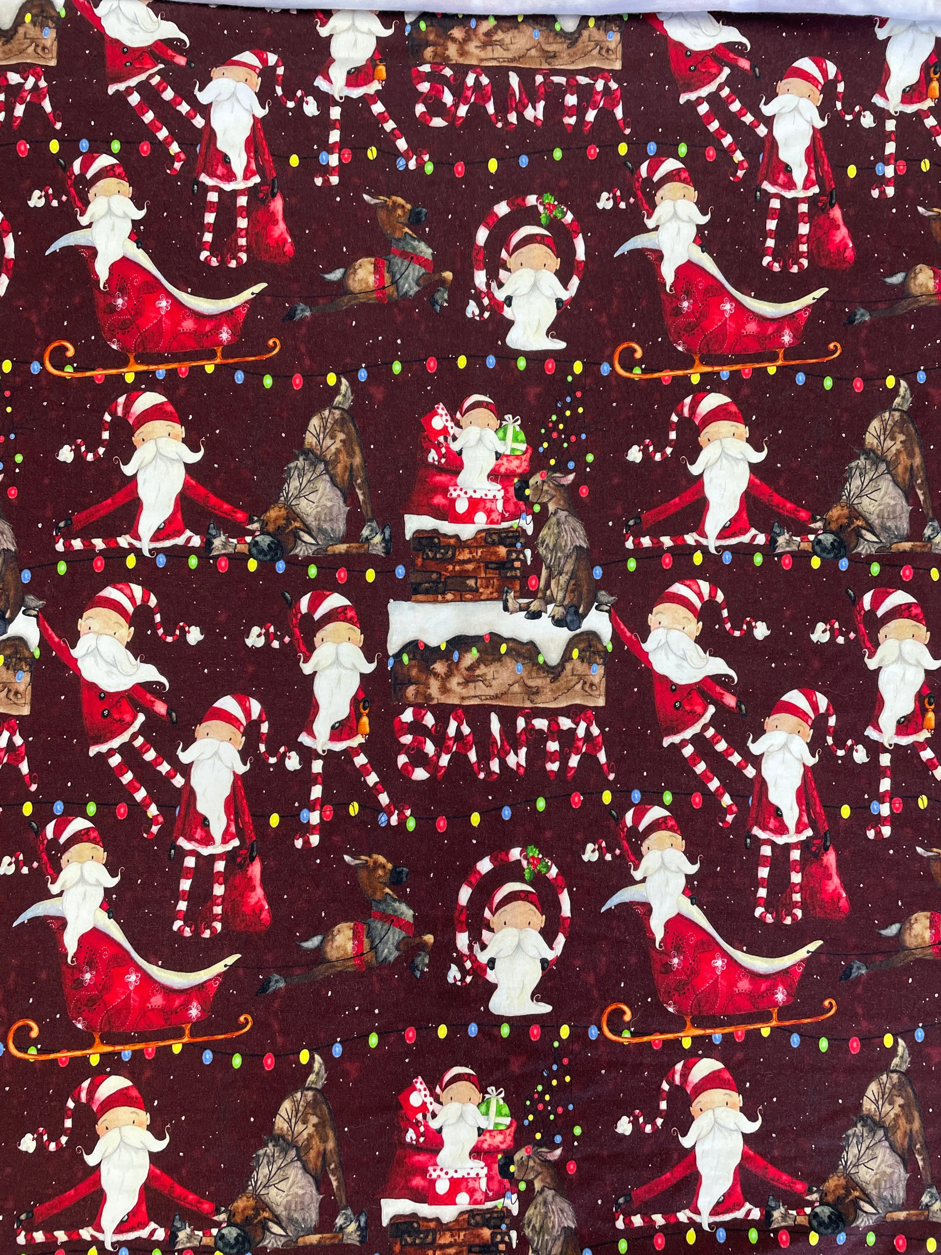 SALE 3/4 YD Cotton/Spandex Remnant - Maroon with Whimsical Santas & Reindeer